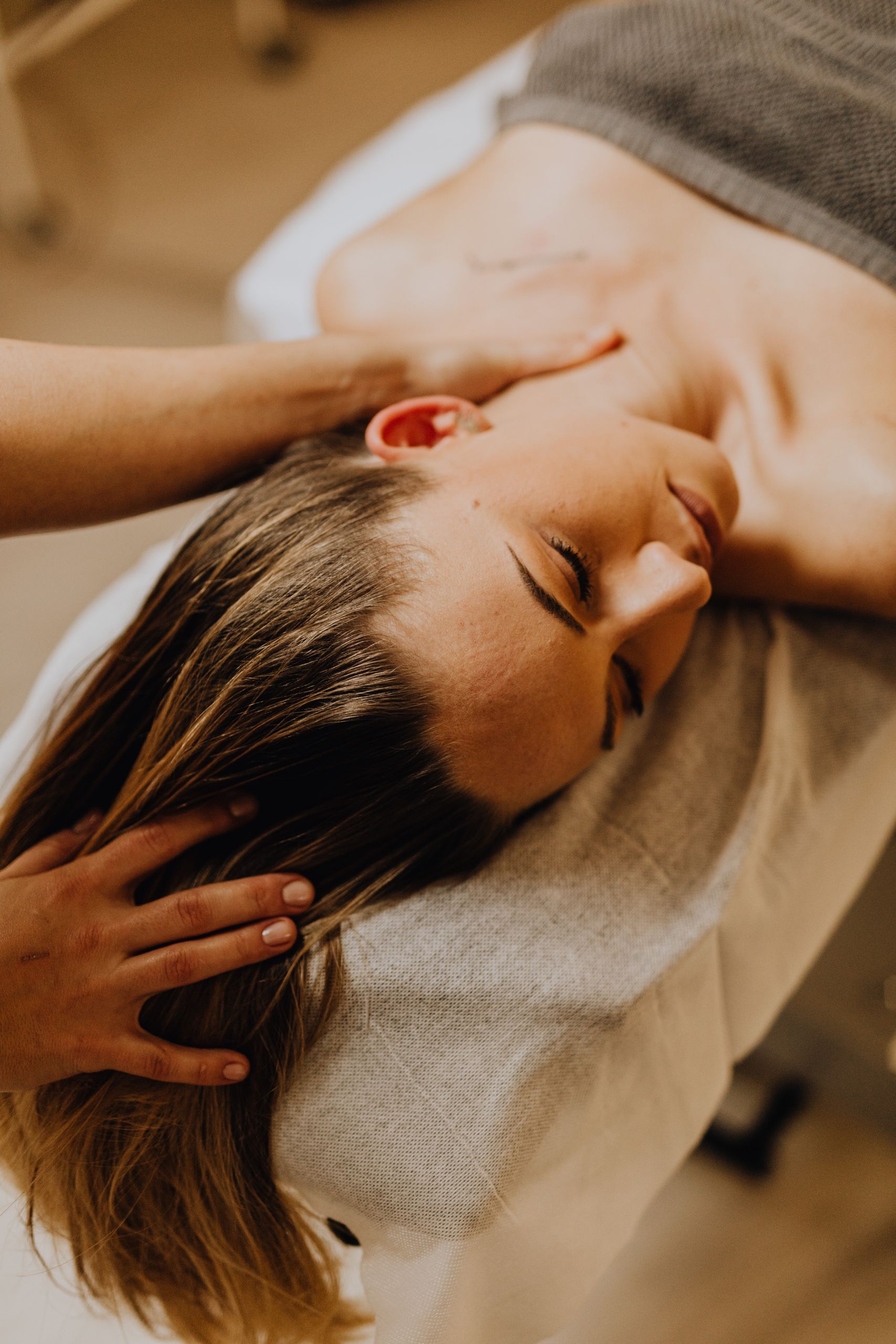 A serene massage therapy session focusing on neck and head relaxation.